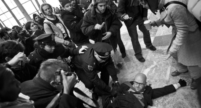 Spectators and citizen journalists film an arrest of an activist by NYPD on their smartphones and digital cameras on December 11, 2011. (Flickr / Jessica Lehrman)