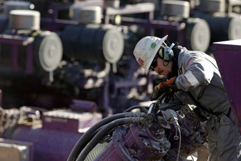 In this March 25, 2014 photo, a worker oils a pump during a hydraulic fracturing operation at an Encana Corp. well pad near Mead, Colo. The first experimental use of hydraulic fracturing was in 1947, and more than 1 million U.S. oil and gas wells have been fracked since, according to the American Petroleum Institute. (AP Photo/Brennan Linsley)