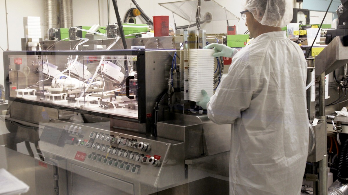Neil Costanzo, a technician at Ortho-Clinical Diagnostics Inc., a Johnson & Johnson company, works in a "sterile filling" room at the plant in Raritan, N.J., Monday, July 17, 2006. (AP Photo/Mike Derer)