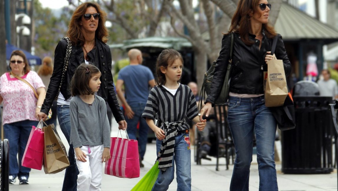In this April 24, 2012, file photo, women and girls carry purchases on the Third Street Promenade in Santa Monica, Calif. The Commerce Department said Friday, April 27, 2012, that the economy expanded at an annual rate of 2.2 percent in the January-March quarter, compared with a 3 percent gain in the final quarter of 2011. Consumers spent at the fastest pace in more than a year. (AP Photo/Reed Saxon, File)