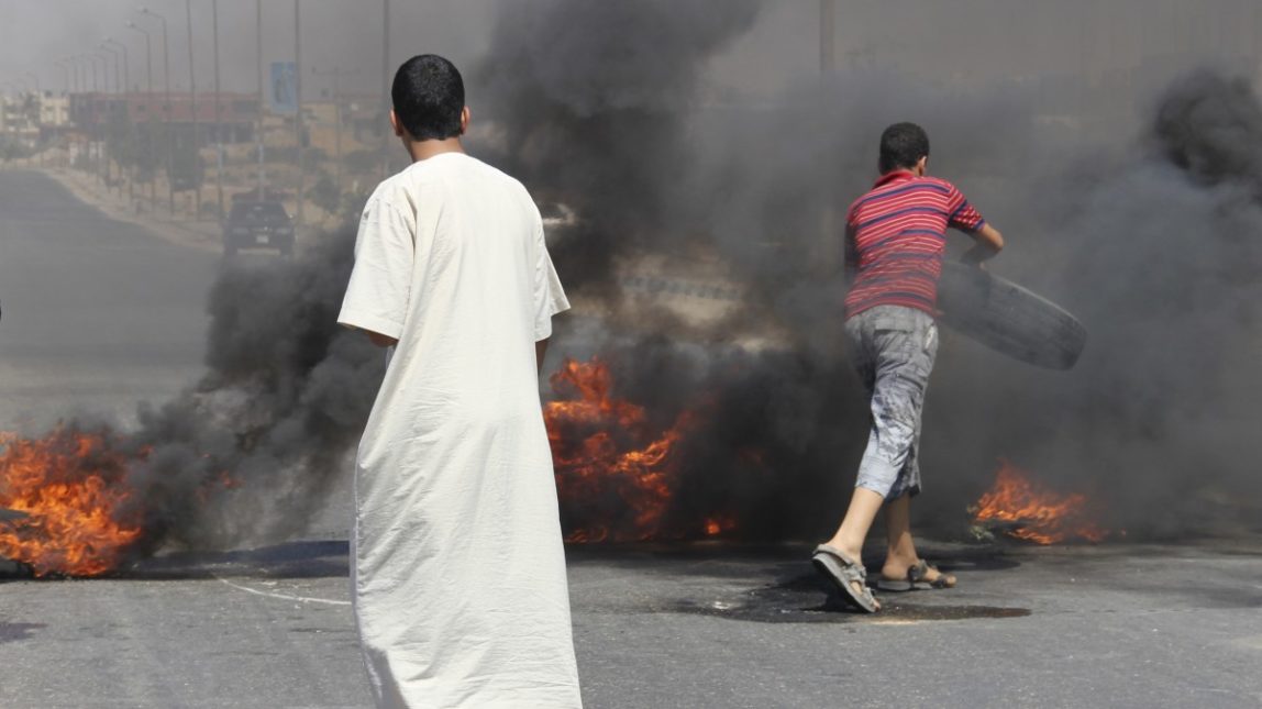 Angered by the attack Sunday evening that left at least 16 on Egyptian soldiers dead, residents of Rafah protest by burning tires in the road on the outskirts Rafah, Egypt, Monday, Aug. 6, 2012. (AP Photo)
