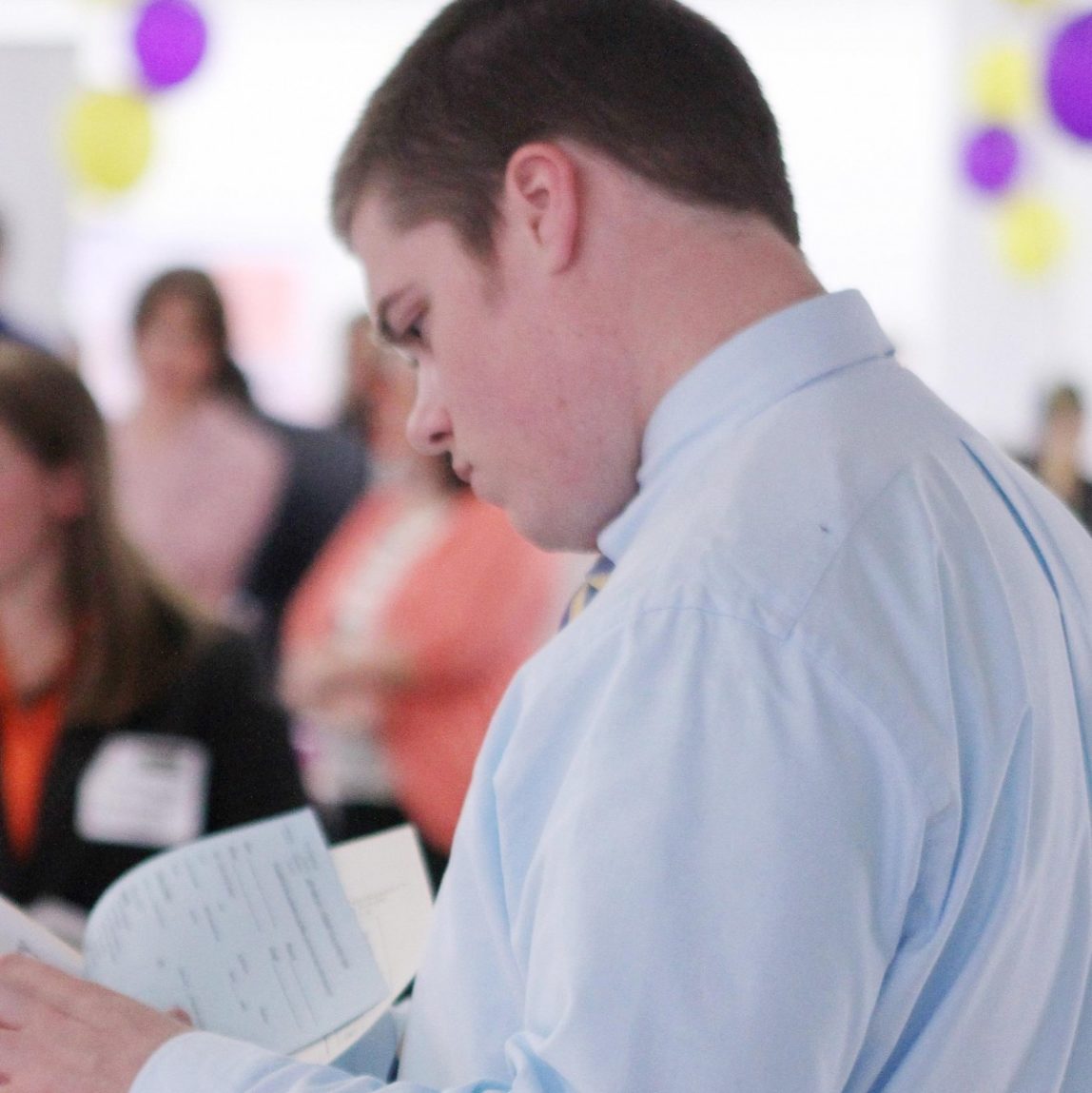 In this April 4, 2012, file photo, Scott Richards of Saint Anselm College looks over possible jobs during a career fair for college students in Manchester, N.H. (AP Photo/Jim Cole, File)