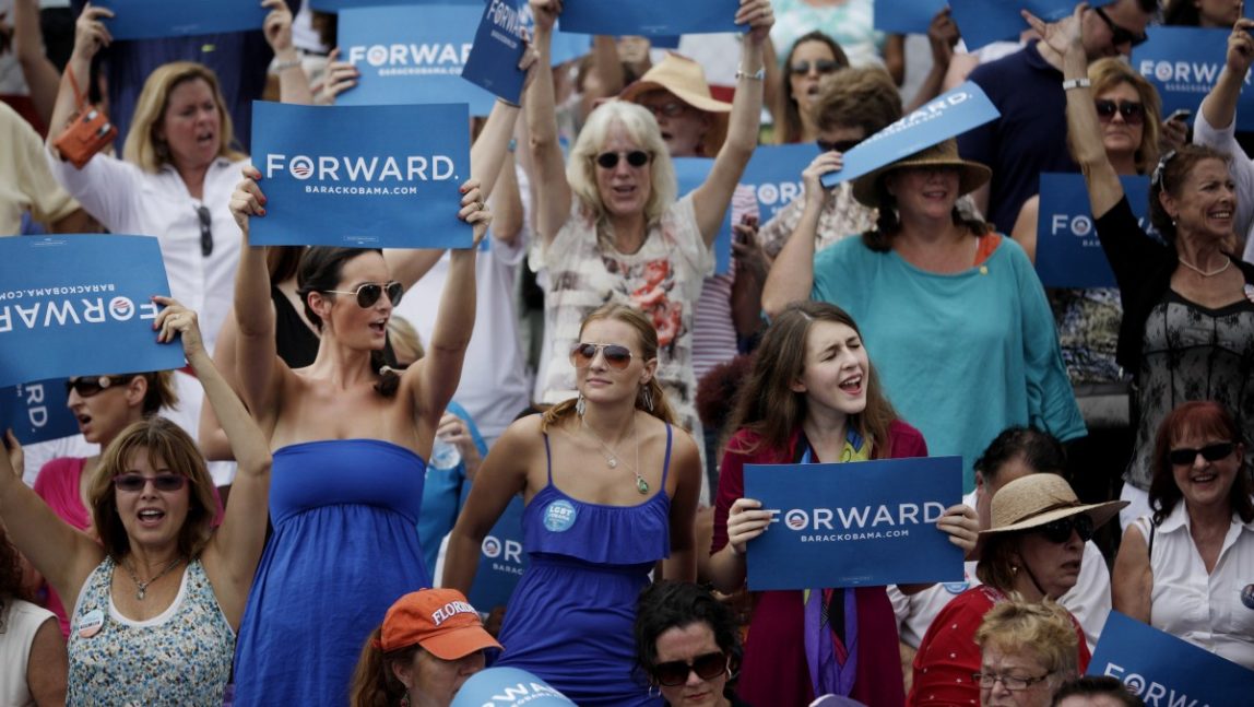 Spectators cheer as President Barack Obama addresses the crowd at a rally at St. Petersburg College's Seminole Campus on Saturday, Sept. 8, 2012 in St Petersburg, Fla. (AP Photo/The Tampa Bay Times, Will Vragovic, Pool)