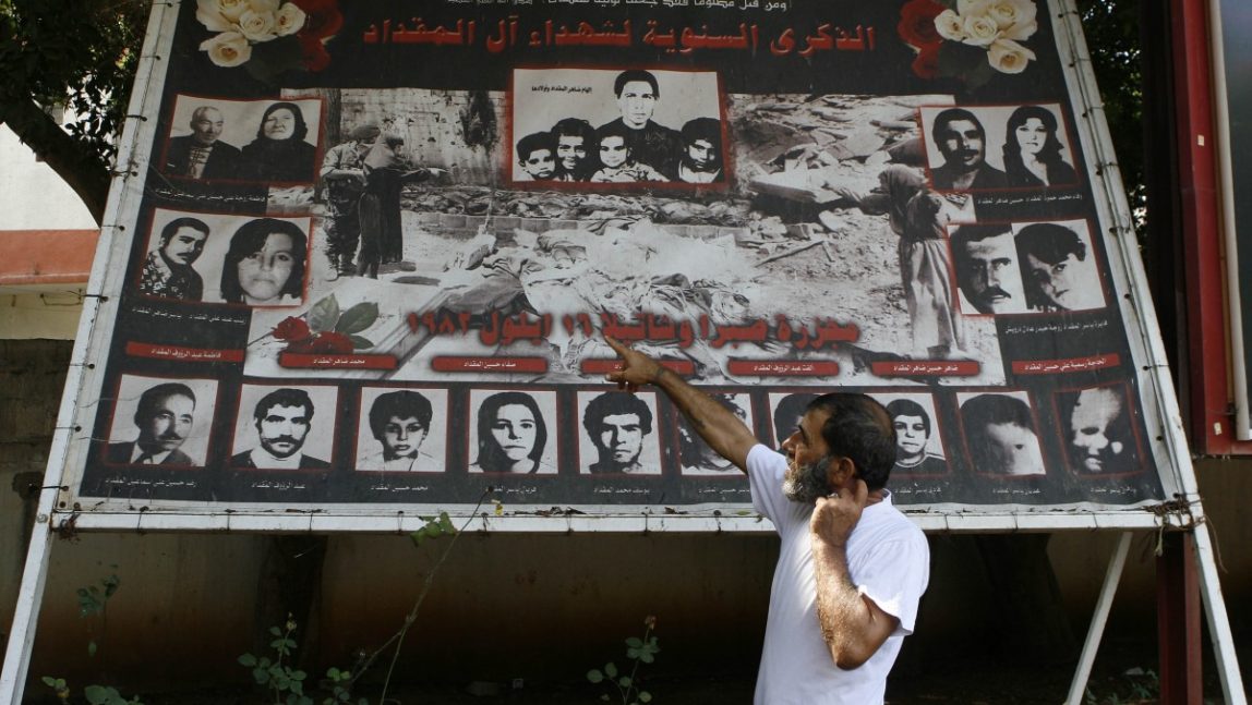 Lebanese man Adnan Miqdad, the caretaker of the graves of those who died in the Sabra and Shatila massacres, points to family members who were killed during the massacres, in a suburb of Beirut, Lebanon, Wednesday Sept. 5, 2007. (AP Photo/Grace Kassab)