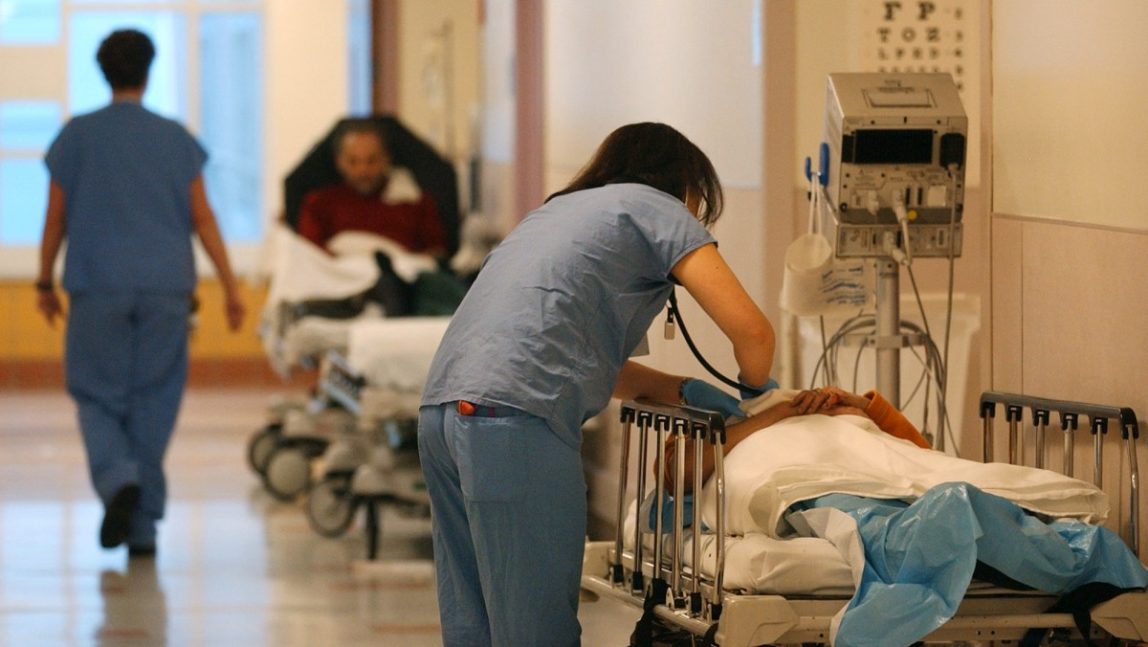 A medical student checks on a patient in the hallway of the emergency room at Harborview Medical Center Wednesday, March 12, 2003, in Seattle. (AP Photo/Elaine Thompson)