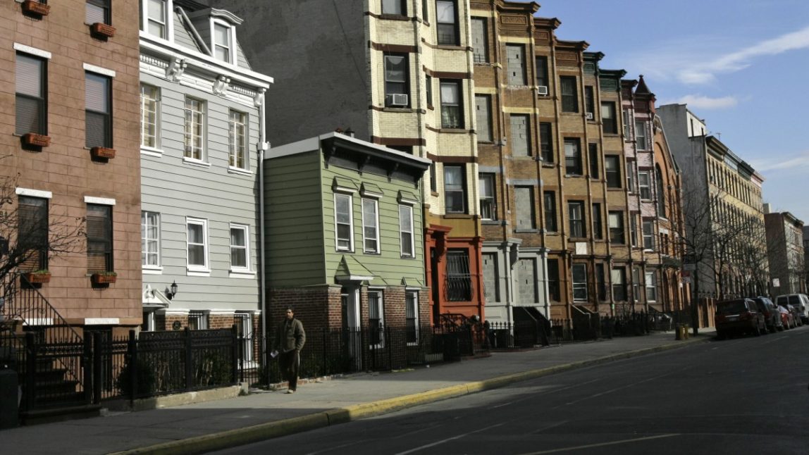 A man walks down a residential Brooklyn street on the site of the proposed $4 billion mega-development Atlantic Yards project in New York, Tuesday, Jan. 23, 2007. (AP Photo/Kathy Willens)