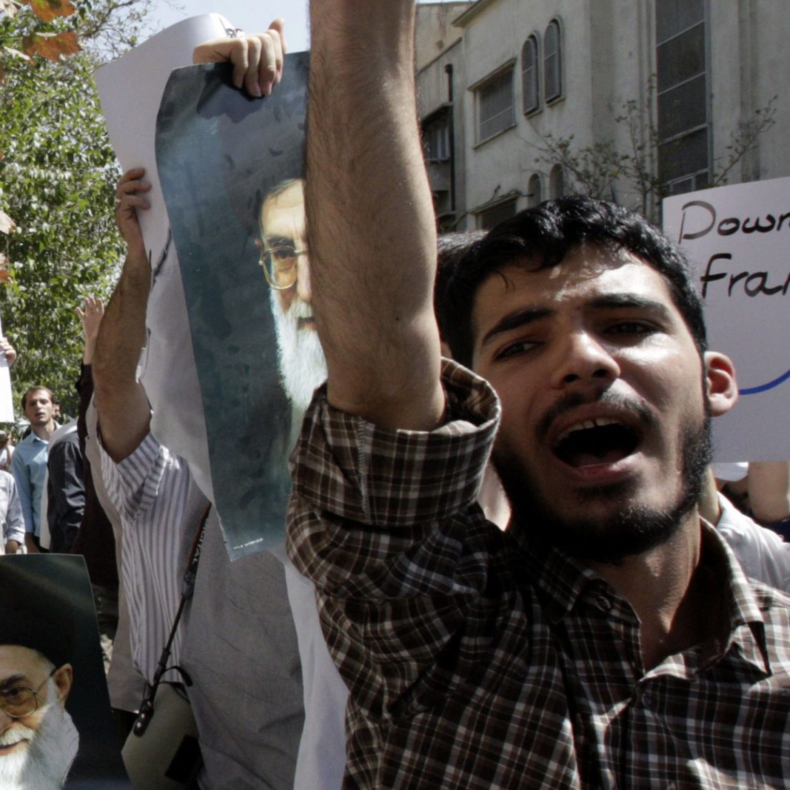 Holding posters of Iranian supreme leader Ayatollah Ali Khamenei, demonstrators chant slogans in front of the French Embassy in Tehran, Iran, Thursday, Sept. 20, 2012, during a protest the publication of caricatures of Islam's Prophet Muhammad by a French satirical weekly. (AP Photo/Vahid Salemi)
