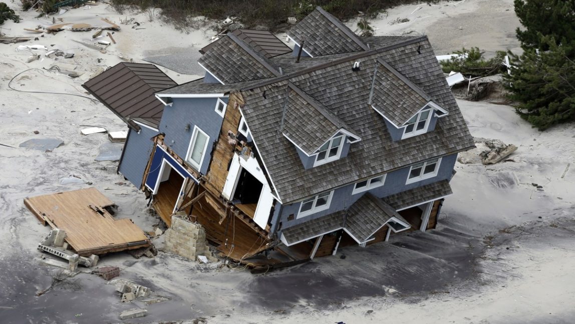This aerial photo shows a collapsed house along the central Jersey Shore coast on Wednesday, Oct. 31, 2012. (AP Photo/Mike Groll)