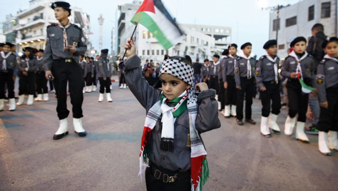 A Palestinian girl waves a flag during a rally supporting the Palestinian U.N. bid for observer state status, in the West bank city of Ramallah, Thursday, Nov. 29, 2012. (AP Photo/Majdi Mohammed)