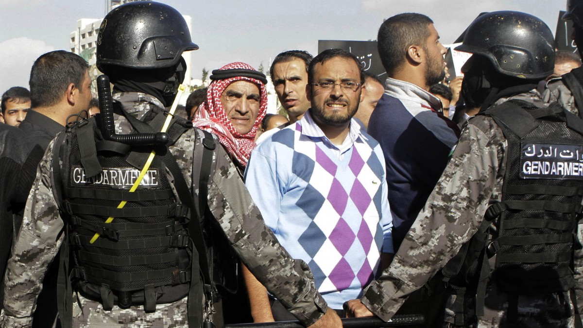 Jordanian police stand guard during a protest against the government's decision to raise prices for subsidized fuel in Amman, Jordan, Monday, Nov. 19, 2012. (AP Photo/Raad Adayleh)