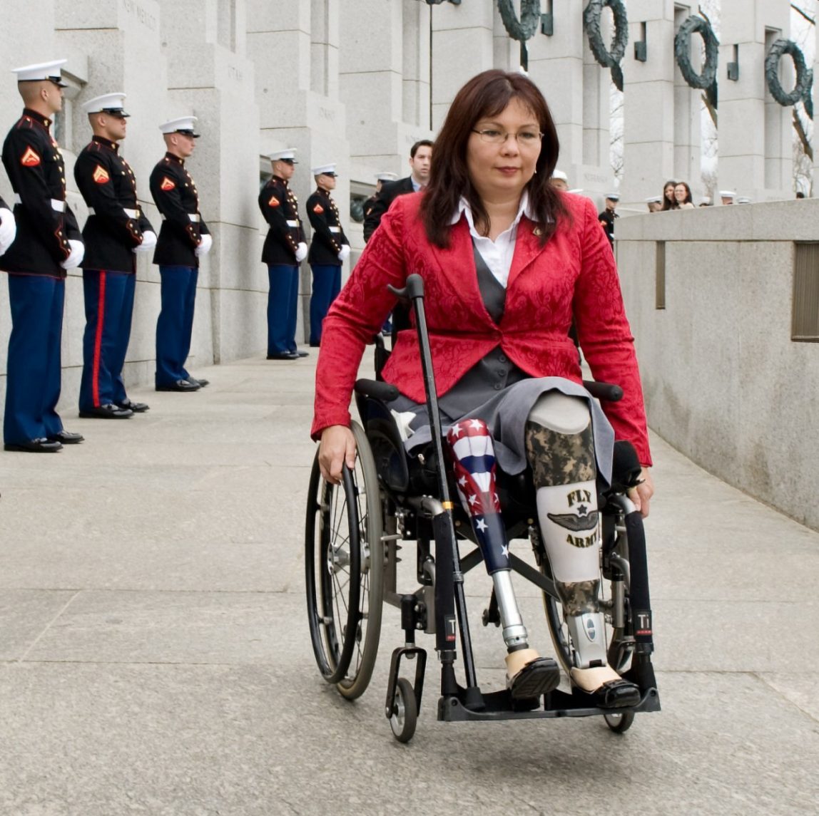 In this Thursday, March 11, 2010 file photo, Tammy Duckworth, assistant secretary for the U.S. Department of Veterans Affairs, arrives at the World War II Memorial in Washington for a ceremony honoring World War II veterans who fought in the Pacific. Duckworth became a double amputee when her National Guard helicopter was shot down in Iraq in 2004. (AP Photo/Cliff Owen)