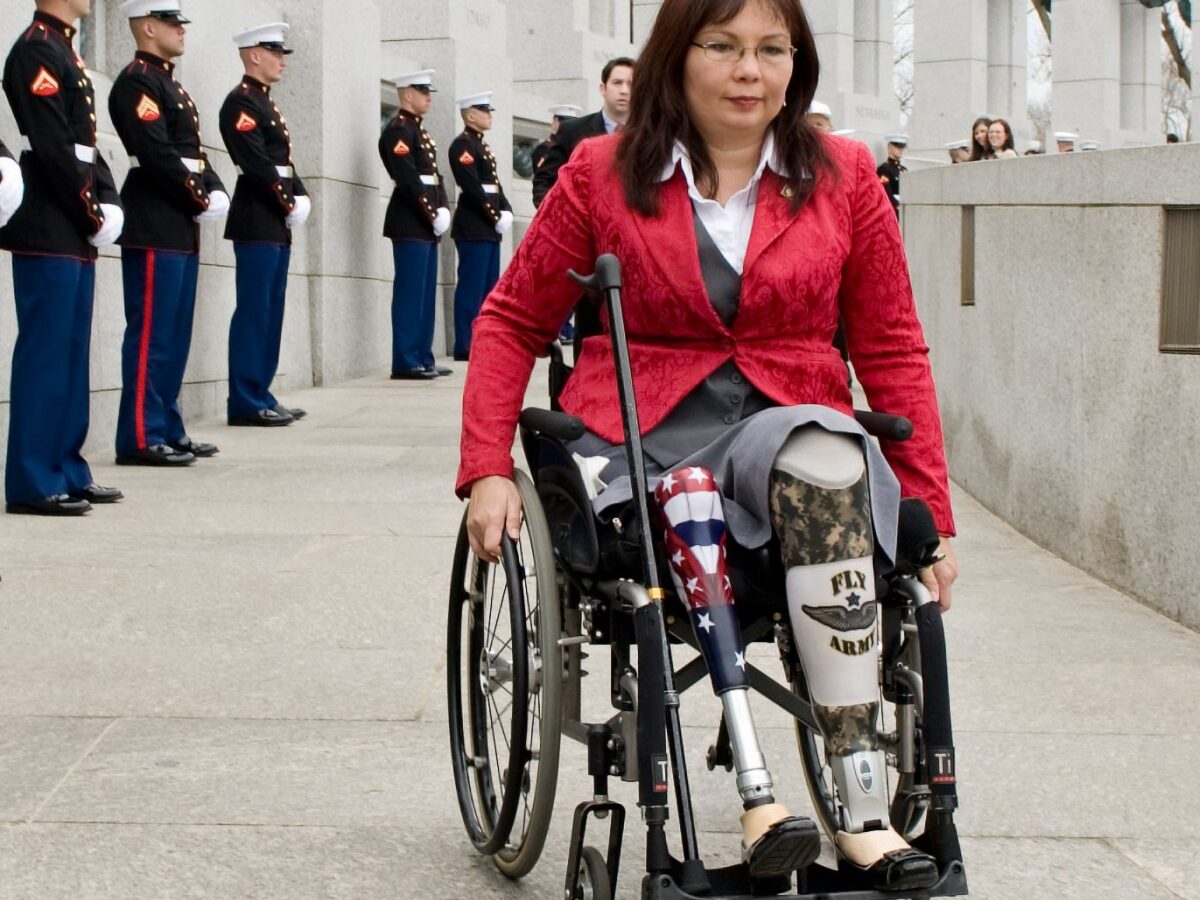 In this Thursday, March 11, 2010 file photo, Tammy Duckworth, assistant secretary for the U.S. Department of Veterans Affairs, arrives at the World War II Memorial in Washington for a ceremony honoring World War II veterans who fought in the Pacific. Duckworth became a double amputee when her National Guard helicopter was shot down in Iraq in 2004. (AP Photo/Cliff Owen)