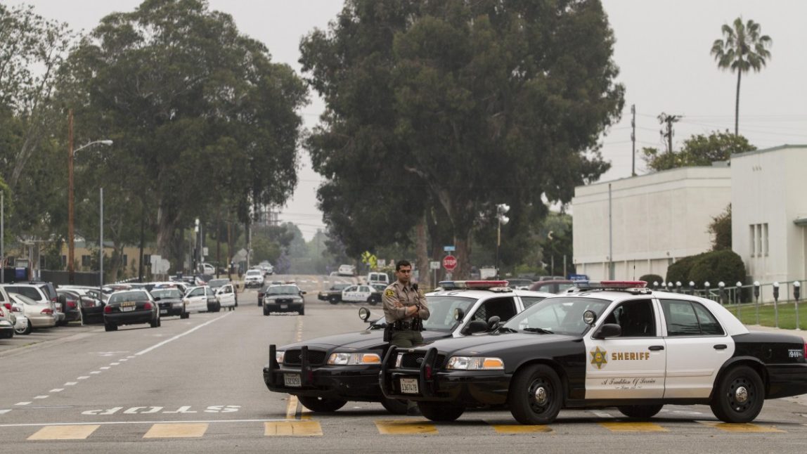 A Los Angeles County Sheriff's officer stands by his car in Santa Monica, Calif. on Saturday, June 8, 2013. (AP/Ringo H.W. Chiu)