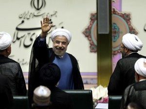Iran's new President Hasan Rouhani, waves after swearing in at the parliament, in Tehran, Iran, Sunday, Aug. 4, 2013. Iran's new president on Sunday called on the West to abandon the "language of sanctions" in dealing with his country over its contentious nuclear program, hoping to ease the economic pressures now grinding its people. Rouhani spoke after being sworn in as president in an open session of parliament Sunday, capping a weekend that saw him endorsed by Ayatollah Ali Khamenei, Iran's supreme leader. (AP Photo/Ebrahim Noroozi)