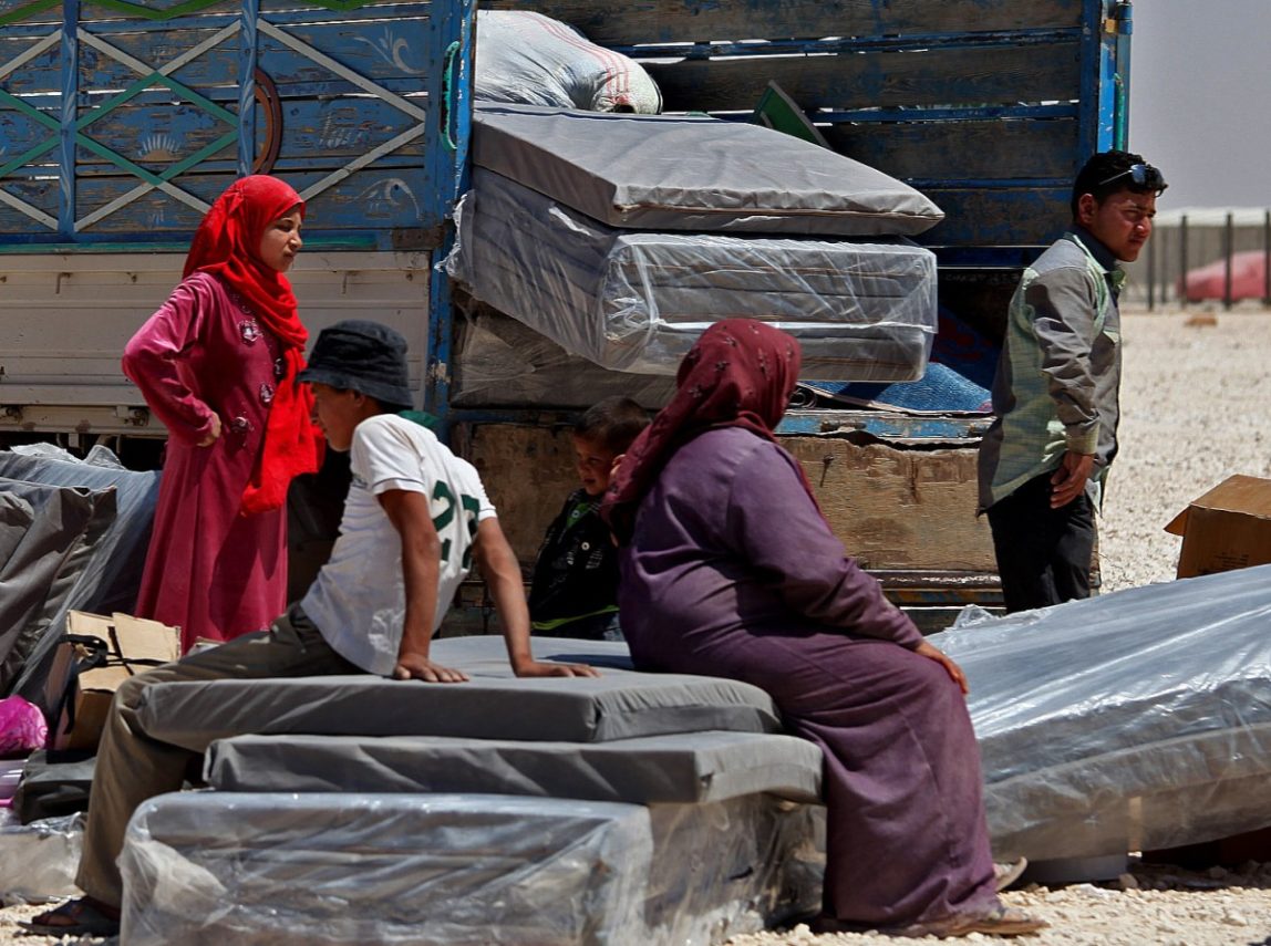 Syrian refugees take down their belongings, on the World Refugee Day, at Zaatari refugee camp, in Mafraq, Jordan, Thursday, June 20, 2013. U.N. refugee chief Antonio Guterres, and the Norwegian foreign Minister, Espen Barth Eide, along with United Nations High Commissioner for Refugees (UNHCR) special envoy, actress Angelina Jolie, held a press conference at the camp to commemorate the World Refugee Day, and to urge the world to support refugees in Syria and around the world. (AP Photo/Mohammad Hannon)