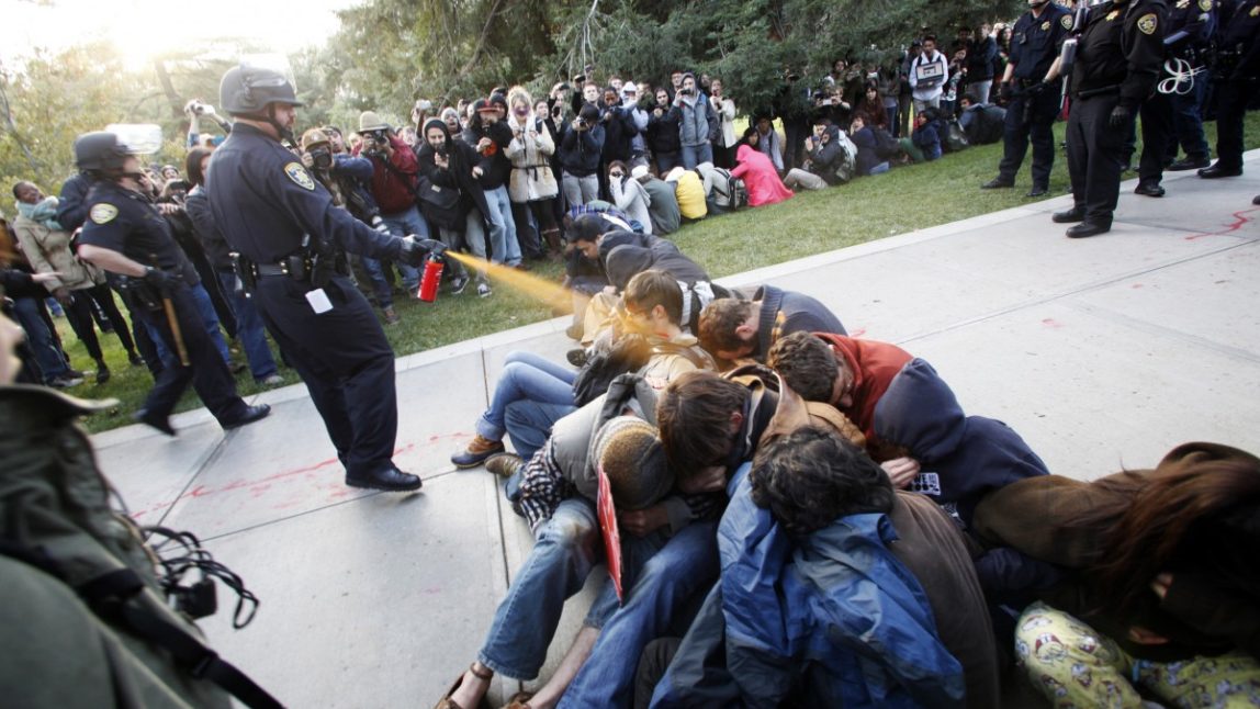University of California, Davis Police Lt. John Pike uses pepper spray to move Occupy UC Davis protesters(AP Photo/The Enterprise, Wayne Tilcock)