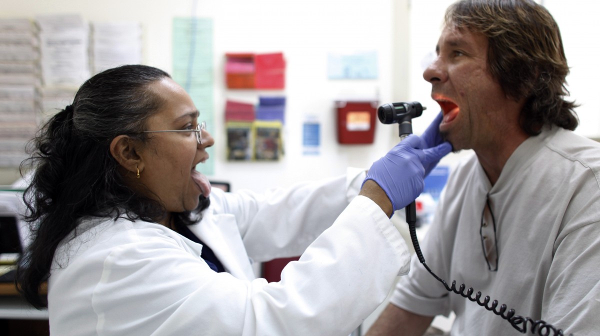 Dr. Hamsakumari Ramasubramaniam, left, examines patient Fabian Vasquez at Camillus Health Concern, Wednesday, June 27, 2012 (AP Photo/Lynne Sladky)