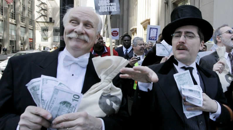 Protesters Richard Hanzel, left, Brendan Hutt, and Richard Shavzin, right, of the Screen Actors Guild, dressed as wall street bankers, march from Goldman Sachs' office to a rally in Federal Plaza demanding Wall Street reform, Wednesday, April 28, 2010, in Chicago. The rally was organized by the Chicago Federation of Labor which includes more than 300 unions with more than 500,000 members. (AP Photo/M. Spencer Green)