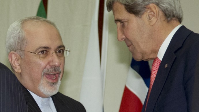 U.S. Secretary of State John Kerry, right, and Iranian Foreign Minister Mohammad Javad Zarif, shake hands at the United Nations Palais, Sunday, Nov. 24, 2013, in Geneva, Switzerland. A deal has been reached between six world powers and Iran that calls on Tehran to limit its nuclear activities in return for sanctions relief, the French and Iranian foreign ministers said early Sunday. (AP Photo/Carolyn Kaster, Pool)