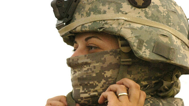 nal Guard's 1/34th Brigade Combat Team buttons her chin strap before heading out on a mission in Iraq, May 2006. (Photo/Minnesota National Guard via Flickr)