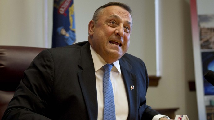 FILE - In this June 26, 2013 file photo, Gov. Paul LePage speaks to reporters shortly after the Maine House and Senate both voted to override his veto of the state budget, at the State House in Augusta, Maine. The Republican governor's clash with Democratic lawmakers over whether to expand Medicaid under the Affordable Care Act ended with the governor's veto - and a vow by Democrats to try again. The story, one of several quarrels between the GOP governor and Democratic-controlled Legislature, was voted the top story of 2013 in Maine in a survey by The Associated Press and its member news organizations in Maine. (AP Photo/Robert F. Bukaty, File)