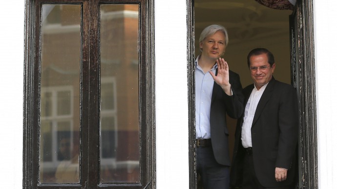 WikiLeaks founder Julian Assange, left, appears with Ecuador's Foreign Minister Ricardo Patino on the balcony of the Ecuadorian Embassy in London, Sunday, June 16, 2013. Assange has been living at the Ecuadorian embassy in London for a year, after the UK Supreme Court refused his appeal against extradition. (AP Photo/Frank Augstein)