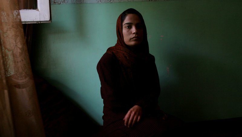 Female Afghan lawmaker, Malalai Joya, sits in a living room during an interview with The Associated Press in Kabul, Afghanistan, Saturday, May 13, 2006. Malalai Joya, a female Afghan lawmaker who two years ago called powerful armed leaders "criminals" and who last week on parliament floor called some lawmakers warlords now moves houses every night because of an influx of death threats, she said. (AP Photo /Rodrigo Abd)