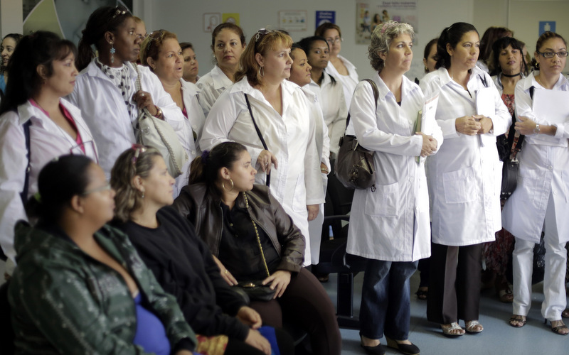 A group of Cuban doctors attend a training session at a health clinic in Brasilia, Brazil, Friday, Aug. 30, 2013. Cuban doctors arriving in Brazil, the first of an expected 4,000 physicians. The arrival is part of the Brazilian government's "More Doctors" program, which is an effort to get physicians working in remote and poor areas of Brazil that are drastically under served in health care. (AP Photo/Eraldo Peres)