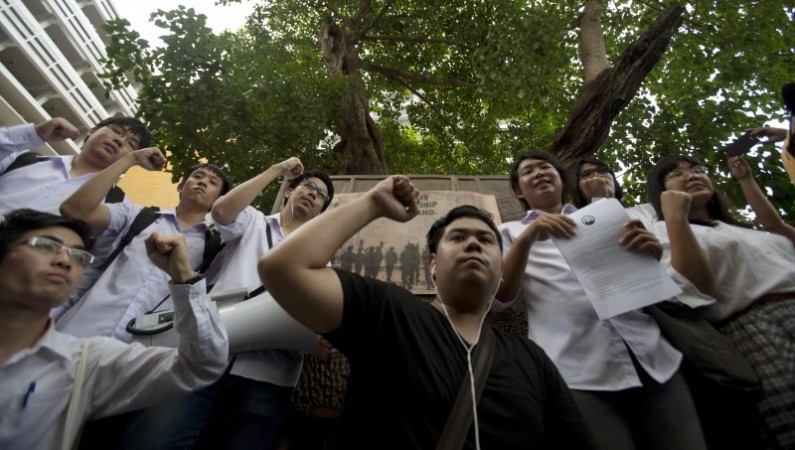 Thai Student Center For Democracy group raise their hand gather at Thammasat University in Bangkok, Thailand, Thursday, May 29 ,2014. On May 22, Thailand's army seized power again without firing a shot, overthrowing a popularly elected administration that won a landslide vote three years earlier. The army says it had to act to restore order after seven months of increasingly violent political turbulence. But the aftermath feels much different this time. (AP Photo/Sakchai Lalit)