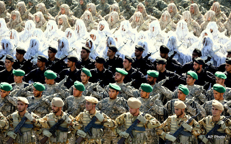 Members of the Iran's armed forces, some wearing ghilli suits, march during an annual military parade marking the 34th anniversary of outset of the 1980-88 Iran-Iraq war, in front of the mausoleum of the late revolutionary founder Ayatollah Khomeini just outside Tehran, Iran, Monday, Sept. 22, 2014.