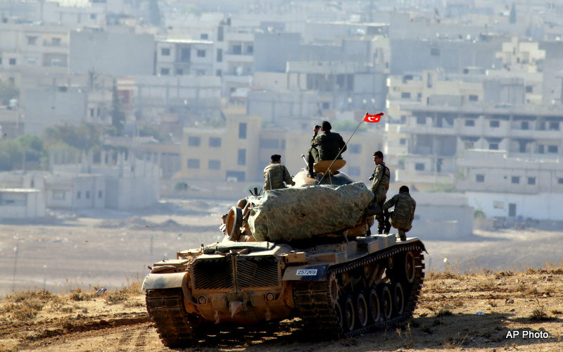 Turkish soldiers on a tank hold their position on a hilltop on the outskirts of Suruc, at the Turkey-Syria border, overlooking Kobani.