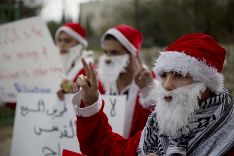 The protester nearest the camera flashes a peace sign.