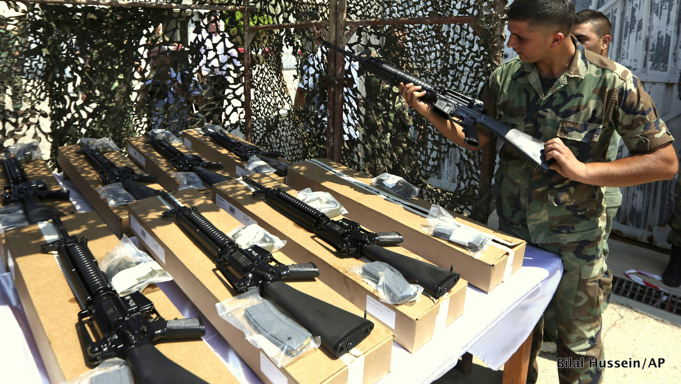 A Lebanese army soldier inspects a rifle at the Rafik Hariri International Airport in Beirut, Lebanon, Friday, Aug. 29, 2014. The United States delivered the first shipment of weapons to Lebanon to help bolster its military as it faces a growing threat from Islamic militants amid the fallout from neighboring Syria's civil war. (AP Photo/Bilal Hussein)