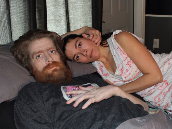 Tomas and Claudia Young, laying together in a bed.