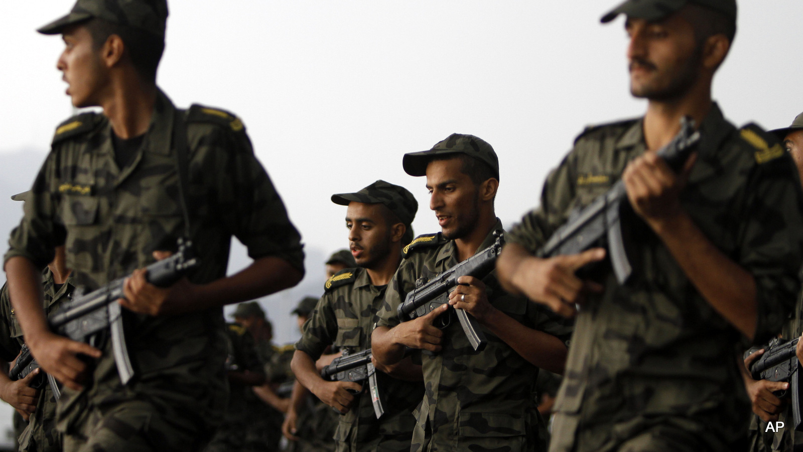 Saudi soldiers exercise before a military parade in preparation for the annual Hajj pilgrimage, at a military camp in Arafat, just outside Mecca, Saudi Arabia, Wednesday, Oct. 9, 2013. The Saudi military will help with security during the annual Hajj pilgrimage which starts upcoming Sunday and is expected to draw some three million Muslim faithful visitors, making it the largest yearly gathering of people in the world. (AP Photo/Amr Nabil)