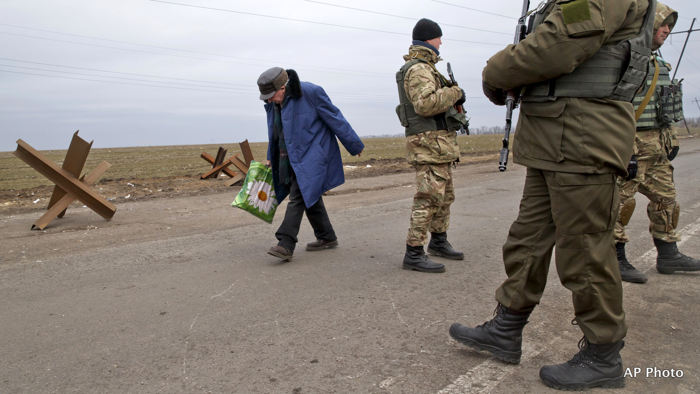 An elderly man crosses a Ukrainian army checkpoint near Kurakhove, Ukraine. (AP Photo/Vadim Ghirda)