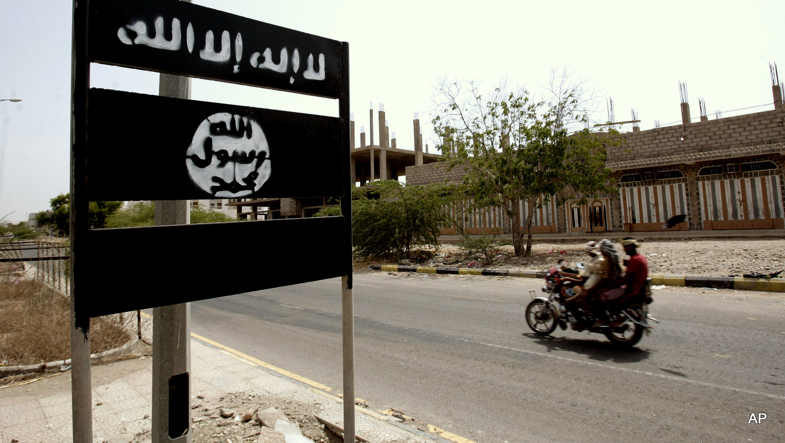 An al-Qaida logo is seen on a street sign in the town of Jaar in southern Abyan province, Yemen. 