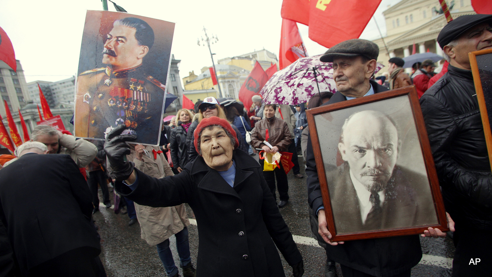 Communists carry portraits of former Soviet leaders Josef Stalin, left, and Vladimir Lenin as they march along Kremlin Towers during a May Day demonstration in Moscow, Friday, May 1, 2015. As in Soviet times, tens of thousands of cheerful workers paraded across Red Square despite a chilly rain, but instead of red flags with the Communist hammer and sickle, they waved the blue flags of the dominant Kremlin party and the Russian tricolor. Participants, who came in groups organized by their trade unions, said the May 1 parade was a tradition going back to their childhood.