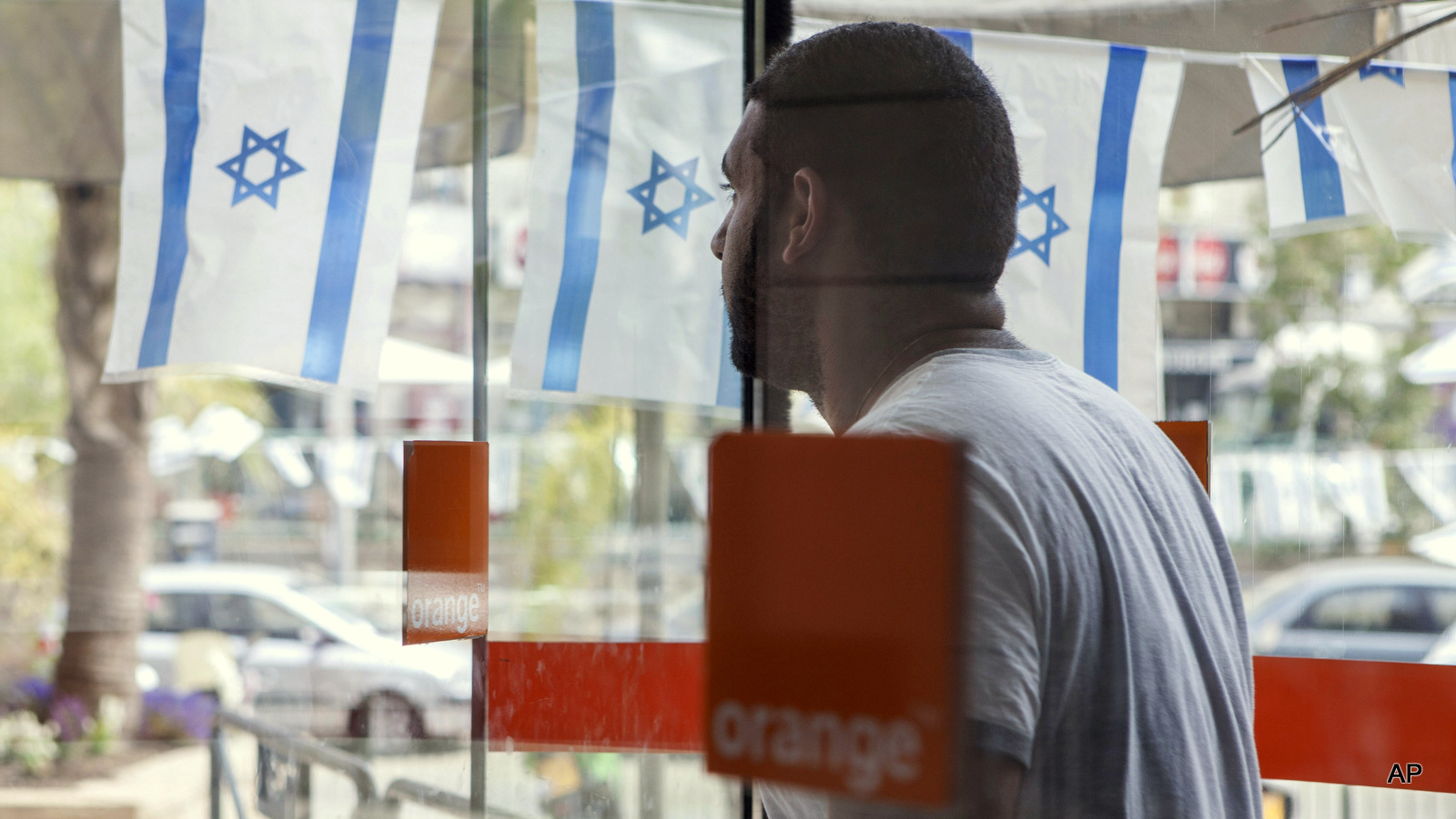 An Israeli man walks out from the "Partner Orange" Communications Company's offices in the city of  Rosh Haain, Israel