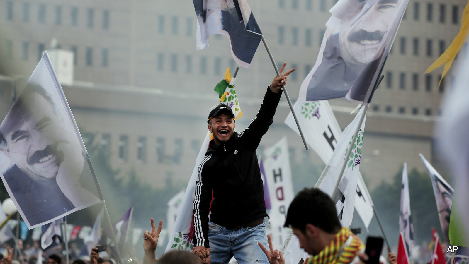 A supporter of the pro-Kurdish Peoples' Democratic Party, (HDP) flashes the V-sign
