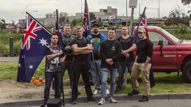 Members of the United Patriots Front, including Neil Erikson (middle in blue jacket) and Blair Cottrell (to his right) behind the ABC's offices in Melbourne. Photo: Meredith O'Shea