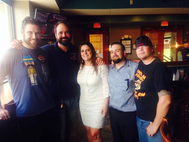 Kris Lewandowski (left) poses with supporters and his lawyer Sarah Swain (middle) after the state dropped felony charges against him and he was freed from jail. (Facebook / The Weed For Warriors Project)
