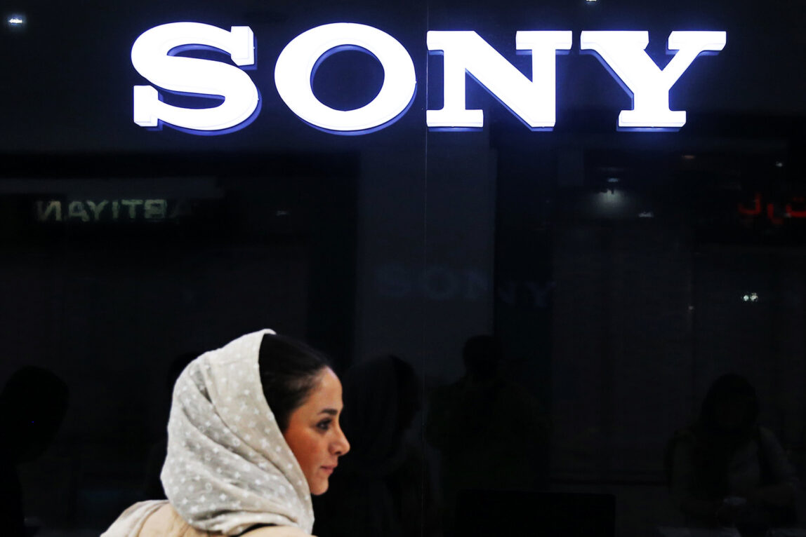 In this picture taken on Friday, July 17, 2015, an Iranian woman walks past a Sony dealer at a shopping center in downtown Tehran, Iran. (AP Photo/Ebrahim Noroozi)