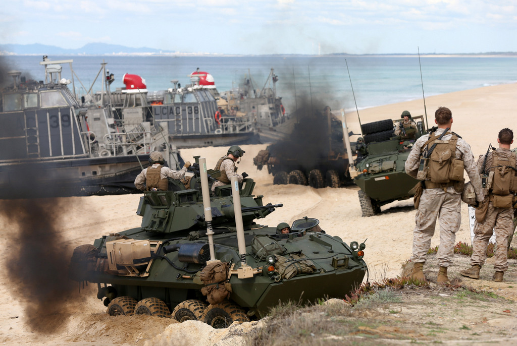 US marine armoured vehicles steers through the soft sand after getting off from a US Navy hovercraft during the NATO Trident Juncture exercise 2015 at Raposa Media beach in Pinheiro da Cruz, south of Lisbon, Tuesday, Oct. 20, 2015. (AP Photo/Steven Governo)