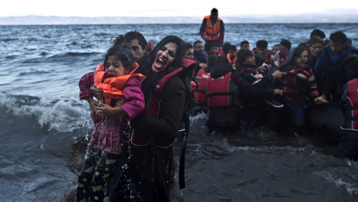 A refugee screams for help after she and her daughter fell into the water after arriving on a dinghy from the Turkish coast to the northeastern Greek island of Lesbos, Friday, Oct. 2 , 2015. The International Organization for Migration says a record number of people have crossed the Mediterranean into Europe this year. (AP Photo/Muhammed Muheisen)