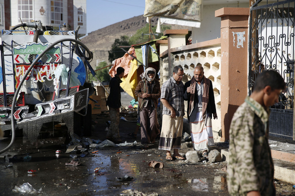 People inspect the site after a suicide bomb attack, Tuesday night, next to a mosque in Sanaa, Yemen, Wednesday, Oct. 7, 2015. The attack killed seven people and wounded three. Islamic State militants claimed responsibility for the blast online. (AP Photo/Hani Mohammed)