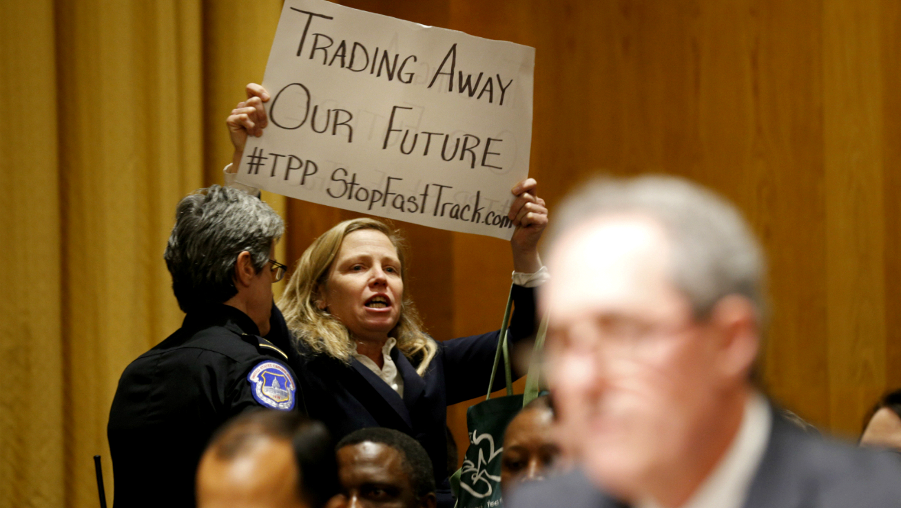 Police remove activist Margaret Flowers for protesting the Trans-Pacific Partnership during a Senate hearing in January. (Reuters/Kevin Lamarque)