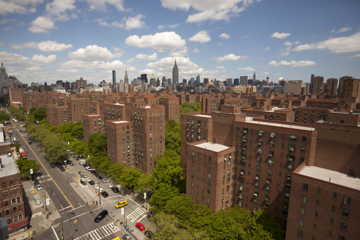 The city skyline stands past Stuyvesant Town-Peter Cooper Village, Manhattan's largest apartment complex, in New York, U.S., on Sunday, May 18, 2014. CWCapital Asset Management LLC, the loan servicer that has been in charge of Stuyvesant Town-Peter Cooper Village since its owners defaulted on a $3 billion mortgage in 2010, is holding a foreclosure sale on June 13 for $300 million of junior loans. While CWCapital holds that debt and is poised to officially take over the property at the auction, other bidders may come with their own plans to pay off bondholders. Photographer: Michael Nagle/Bloomberg
