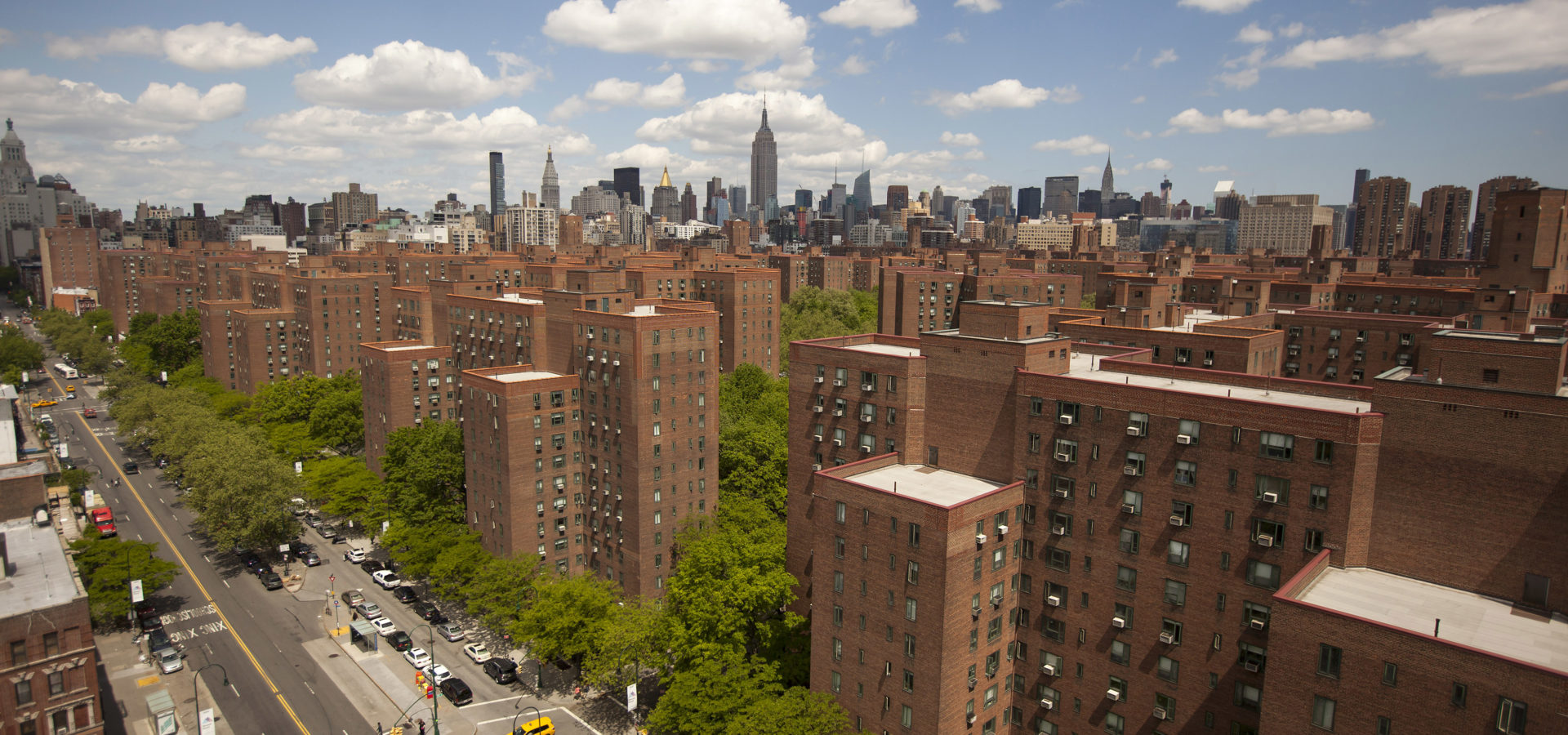 The city skyline stands past Stuyvesant Town-Peter Cooper Village, Manhattan's largest apartment complex, in New York, U.S., on Sunday, May 18, 2014. CWCapital Asset Management LLC, the loan servicer that has been in charge of Stuyvesant Town-Peter Cooper Village since its owners defaulted on a $3 billion mortgage in 2010, is holding a foreclosure sale on June 13 for $300 million of junior loans. While CWCapital holds that debt and is poised to officially take over the property at the auction, other bidders may come with their own plans to pay off bondholders. Photographer: Michael Nagle/Bloomberg