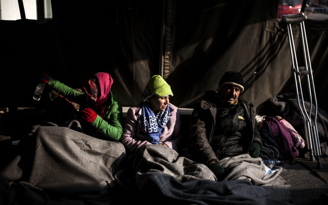 Syrian refugees are seen within a tent at the railway station of Sid, where Serbian authorities load trains with refugees to Crotia. Sid, Serbia, Friday, Nov. 6, 2015 (AP/Manu Brabo)